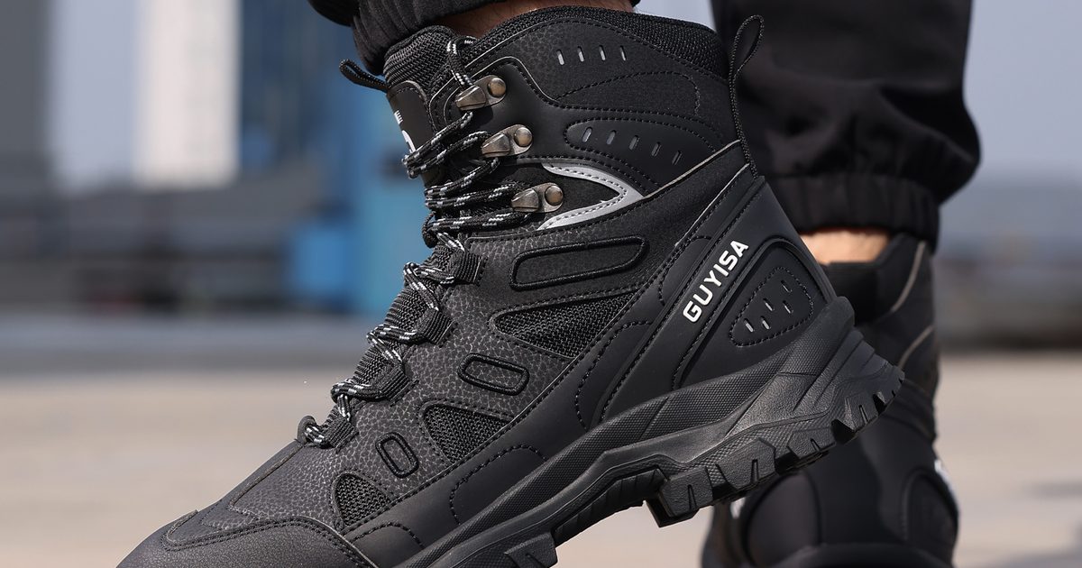 Black high-top safety work boot on a construction site